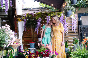 Mutter und Tochter stehen im Blumenladen - AMWF01867