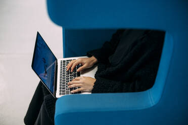 Geschäftsfrau tippt auf Laptop-Tastatur im Büro sitzend - JOSEF21352