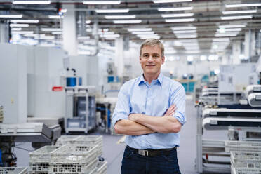 Portrait of a confident businessman in a factory - DIGF20686
