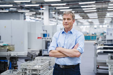 Portrait of a confident businessman in a factory - DIGF20688