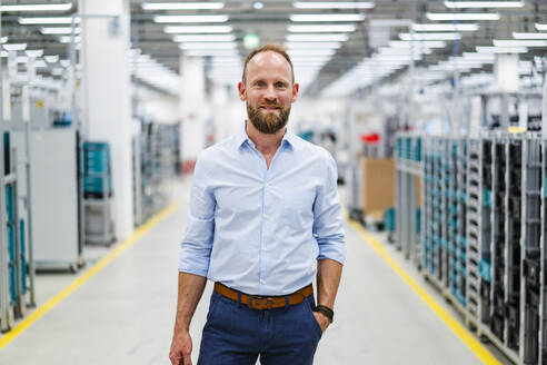 Portrait of a confident businessman in a factory - DIGF20822