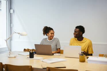 Happy young students studying together at university - EBSF03859