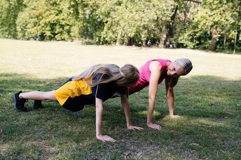 Glückliche Mutter und Tochter beim Sport im Park - AMWF01880