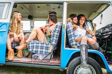 Group of friends travelling with a vintage minivan - Hippies driving into the nature - DMDF06880