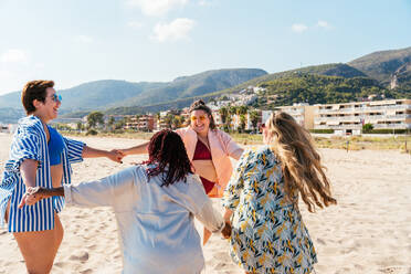 Group of beautiful plus size women with swimwear bonding and having fun at  the beach - Group