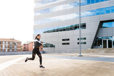 Sportive girl with fit body training outside - Beautiful woman doing some sport exercises, concepts about health, lifestyle and functional training - DMDF06996