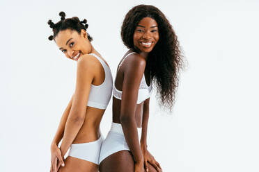 Beauty portrait of beautiful black women wearing lingerie underwear - Pretty african young women posing in studio, concepts about beauty, cosmetology and diversity - DMDF07183