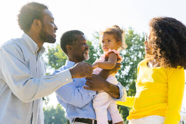 Beautiful happy african american family bonding at the park - Black family having fun outdoors - DMDF07209