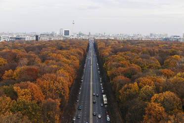 Deutschland, Berlin, Autobahn umgeben von herbstlichen Parkbäumen von der Siegessäule aus gesehen - MMPF00974