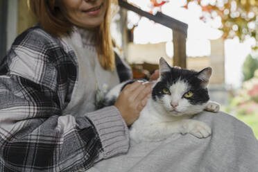 Farmer with cat resting on porch - VBUF00436