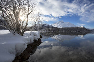 Snowcapped mountains reflected in the icy Lake Sils during a cold winter, Engadine, Canton of Graubunden, Switzerland, Europe - RHPLF28490