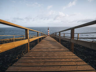 Farolim dos Fenais da Ajuda lighthouse with a symmetrical wooden path leading to it, Sao Miguel island, Azores Islands, Portugal, Atlantic, Europe - RHPLF28524