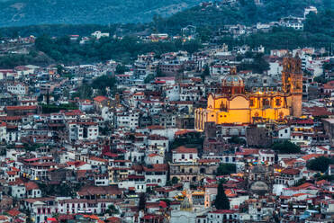 Evening overview, with illuminated Church of Santa Prisca de Taxco, Taxco, Guerrero, Mexico, North America - RHPLF28598