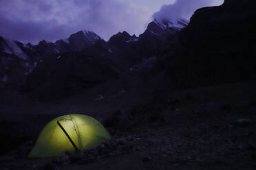 Trekker's tent lit inside at night in the remote and spectacular Fann Mountains, part of the western Pamir-Alay, Tajikistan, Central Asia, Asia - RHPLF28613