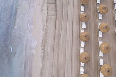 Drone view of beach straw umbrellas on an empty beach, Sicily, Mediterranean Sea, Italy, Europe - RHPLF28654