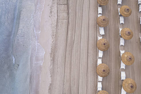 Drone view of beach straw umbrellas on an empty beach, Sicily, Mediterranean Sea, Italy, Europe - RHPLF28654