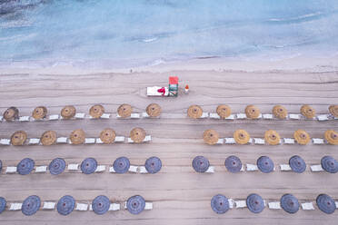 Aerial view of rows of beach umbrellas with a lifeguard tower on an sandy beach, Sicily island, Italy, Mediterranean Sea, Europe - RHPLF28657