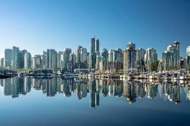 Skyline of Vancouver, with perfect reflection of skyscrapers in the blue waters of Stanley Park, Vancouver, British Columbia, Canada, North America - RHPLF28680