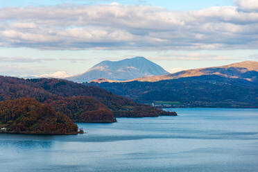 View over the forest slope of Lake Toya in the evening with volcano in the distance, Abuta, Hokkaido, Japan, Asia - RHPLF28701