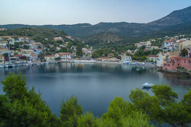 Elevated view of harbour and colourful houses in Assos at dusk, Assos, Kefalonia, Ionian Islands, Greek Islands, Greece, Europe - RHPLF28765