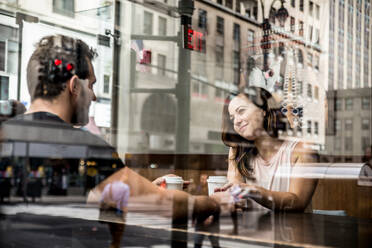 Couple of lovers drinking coffee in a coffehouse bar - DMDF07416