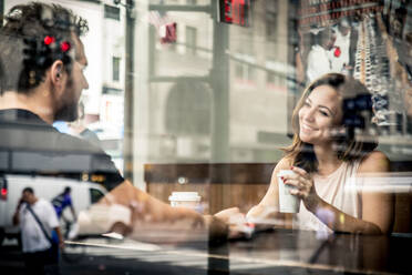 Couple of lovers drinking coffee in a coffehouse bar - DMDF07417