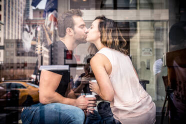 Couple of lovers drinking coffee in a coffehouse bar - DMDF07420