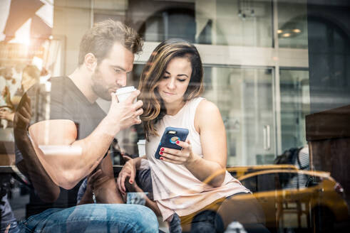 Couple of lovers drinking coffee in a coffehouse bar - DMDF07421