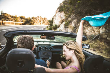 Couple of lovers driving on a convertible car - Newlywed pair on a romantic date - DMDF07449