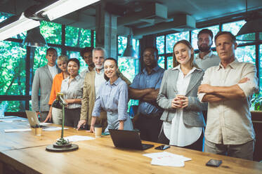 Cinematic image of people working in a start up business. Multiethnic team of experts working together to develop the new projects - DMDF07528