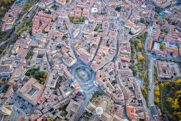 Breathtaking drone view of houses with red roof on Segovia city located in valley near mountains and lush woodland on sunny day in Avila, Spain - ADSF48063