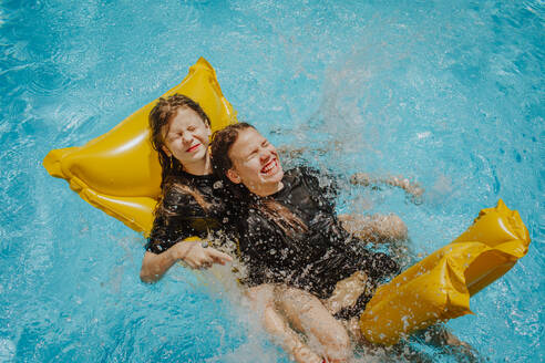 Glückliche Mädchen haben Spaß im Schwimmbad - MDOF01587