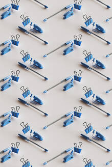3D pattern of blue colored office supplies floating against white background - GCAF00441