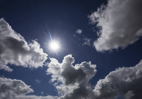 Sun glowing between cumulus clouds - WWF06575