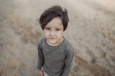 Boy standing on sand at beach - ANAF02255