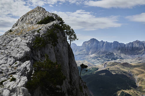 Gorge with rough giant rocks in Pena Foratata mountain range located against blue sky in nature of Aragon Pyrenees in Spain - ADSF48195