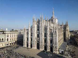 Aerial view of Milan with crowd near old buildings and Metropolitan Cathedral-Basilica of Nativity of Saint Mary in Italy in daylight - ADSF48230