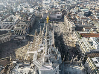 Drone view of rooftop of medieval Catholic cathedral Notre Dame and tourists on street in Paris in sunlight - ADSF48232