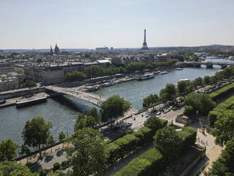 Drone view of Paris city with Alexandre III bridge over Seine river and green trees on sunny summer day - ADSF48237