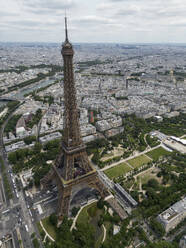 From above of picturesque view of famous Eiffel Tower located on green hill against cloudy sky in Paris - ADSF48243