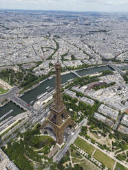 From above of picturesque view of famous Eiffel Tower located on green hill against cloudy sky in Paris - ADSF48244