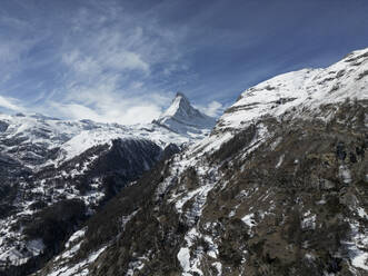 Amazing view of rough peaks in snow of Alp mountain ridge in valley of Switzerland under blue sky - ADSF48246