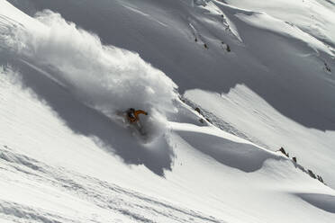 Top view of unrecognizable sportsman riding snowboard on snowy mountain in winter - ADSF48267