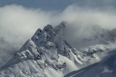 Picturesque view of rocky snowy mountains located against blue sky in winter on Ushuaia Argentina - ADSF48286