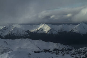 Picturesque view of rocky snowy mountains located against cloudy sky in winter on Ushuaia Argentina - ADSF48292