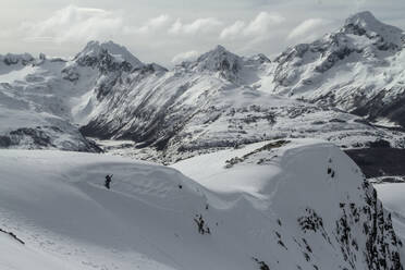 Picturesque view of rocky snowy mountains located against cloudy sky in winter on Ushuaia Argentina - ADSF48299