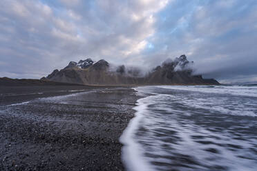 Amazing view of black sand Stockness beach and Vestrahorn mountain in background in Iceland - ADSF48320