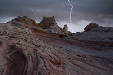 Picturesque scenery of rough rocky mountains under stormy dark sky with lightnings in evening in Utah in USA - ADSF48341