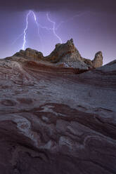 Picturesque scenery of rough rocky mountains under stormy dark sky with lightnings in evening in Utah in USA - ADSF48344