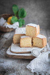 From above wooden board with Pasiego cake a typical cake from Catalonia in Spain sprinkled with sugar on rustic wooden table - ADSF48387